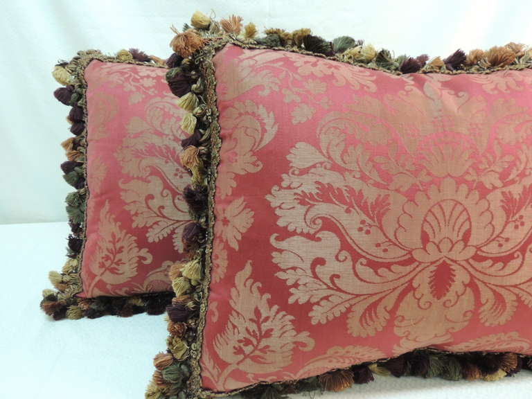 red pillow with gold tassels