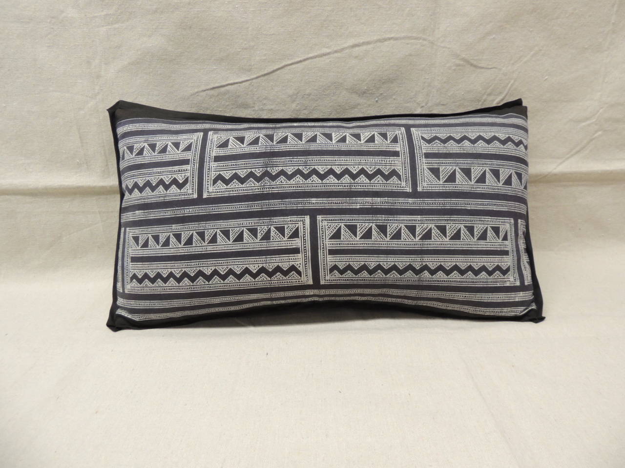 Dark indigo (almost black) tribal design batik hand-blocked lumbar pillow with matte black linen backing and custom black flat trim all around.
Decorative pillows handcrafted and designed in the USA. Closure by stitch (no zipper closure) with a