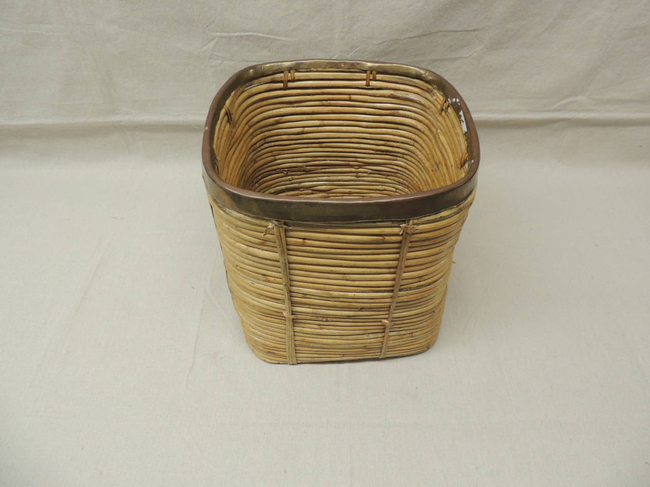 Vintage bamboo waste basket/magazine holder. reed bamboo with antique brass rim.