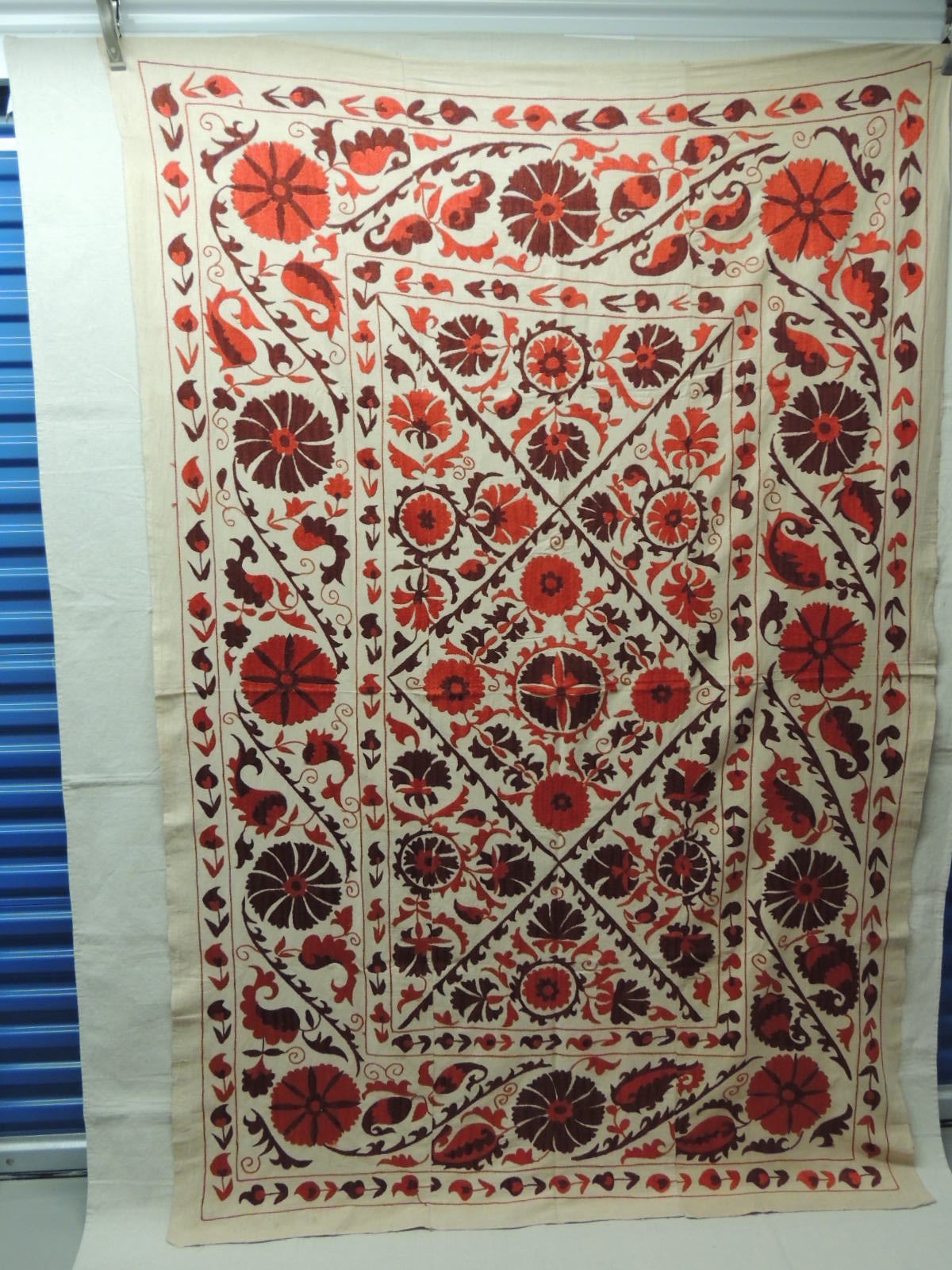 Large vintage Suzani artisanal panel embroidered with flowers in shades of brown and deep orange. Ideal on a table, sofa, bed or chair.  
Suzanis were traditionally made by Central Asian brides as part of their dowry, and were presented to the groom