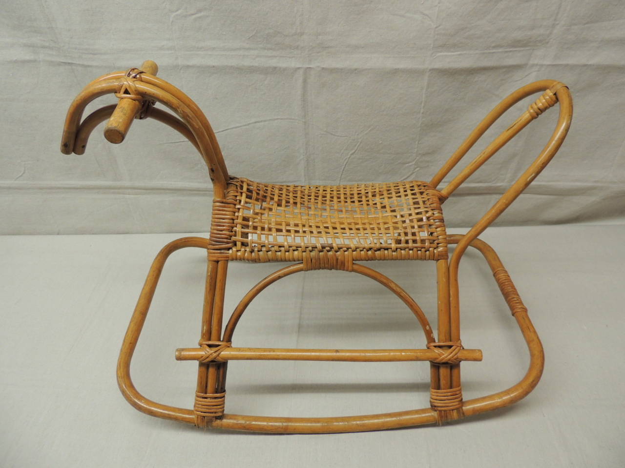 Child's rattan and bamboo child's rocking horse Mid-Century design with basket weave seat.