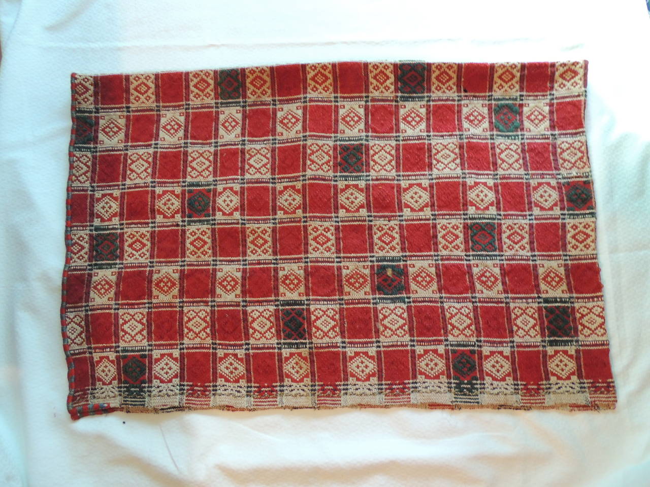 Anatolian checkerboard antique textile in shades or red, natural and green, each square is hand-knotted to create the large piece, basket weave pattern textured linen.
