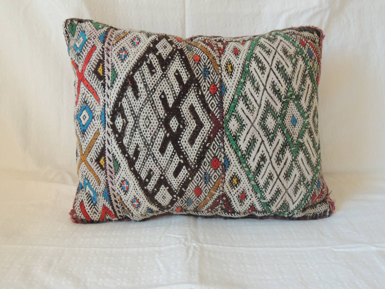 Vintage Green and black Moroccan decorative pillow, with kilim texture textile. and stripe red backing.
