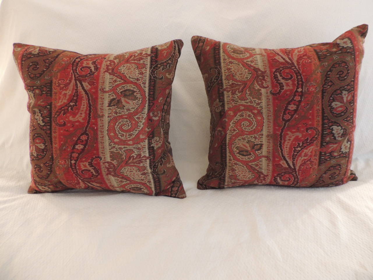 Pair of antique textile stripe paisley Kashmir decorative pillows handcrafted from a shawl texture wool and moss green linen backings. In shades of tan, red, green, black.  Kashmir handmade shawls’ are textiles handcrafted by artisans with fine wool