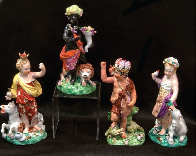 Fantastic complete porcelain set of the Four Corners of the Earth by Derby. The figures are children. Representing America is an Indian boy with a feathered headdress and bow and arrow, at his feet an alligator. A girl represents Europe, crowned as