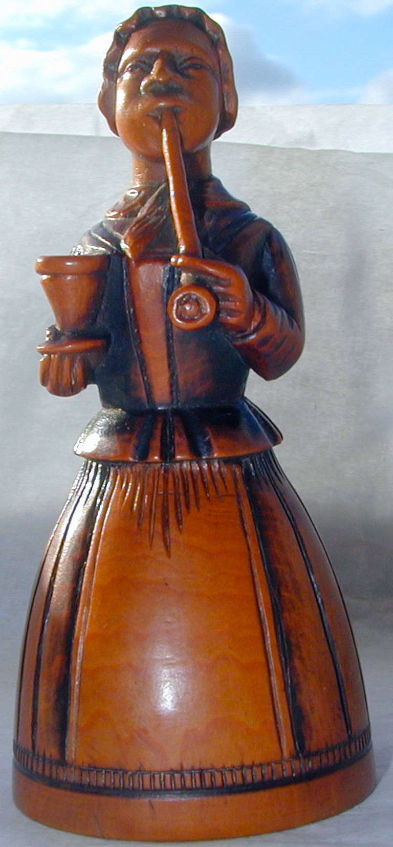 Rare Georgian beautifully carved boxwood candlesnuffer in the form of a lady smoking a pipe and holding, perhaps, a glass of ale.  This amazing piece measures 1 1/4