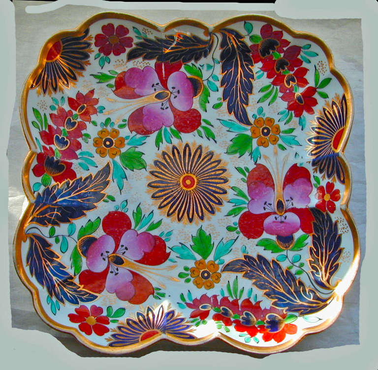 Striking clematis pattern square serving dish by Worcester. This porcelain dish is boldly painted in brilliant tones of cobalt, red, purple, green and aqua highlighted by gilding. The dish measures 9