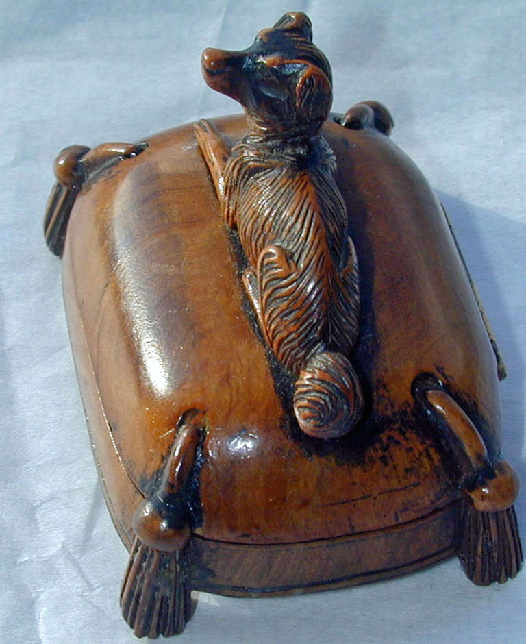 Beautifully carved VictorIan stamp box of a Spaniel on a tasseled cushion. A wonderful addition to an antique desk. The box measures 2 1/2