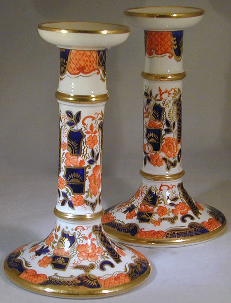 Pair of English porcelain candlesticks decorated in the Imari style with gilding will brighten your dining table and enliven your guests. These early candlesticks, which measure 7 1/4