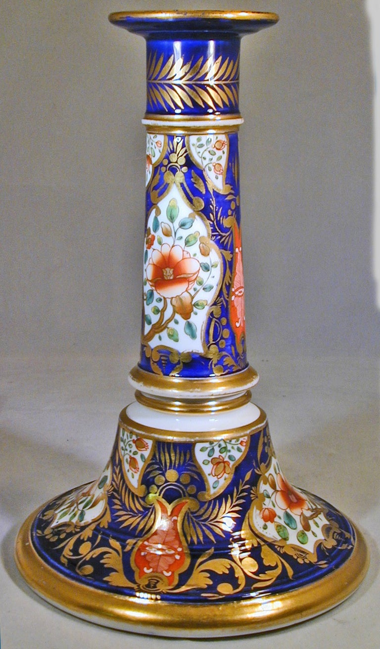 Pair of Spode beautifully decorated Imari patterned porcelain candelsticks. These rare pieces would be stunning lighting up a dining room table.