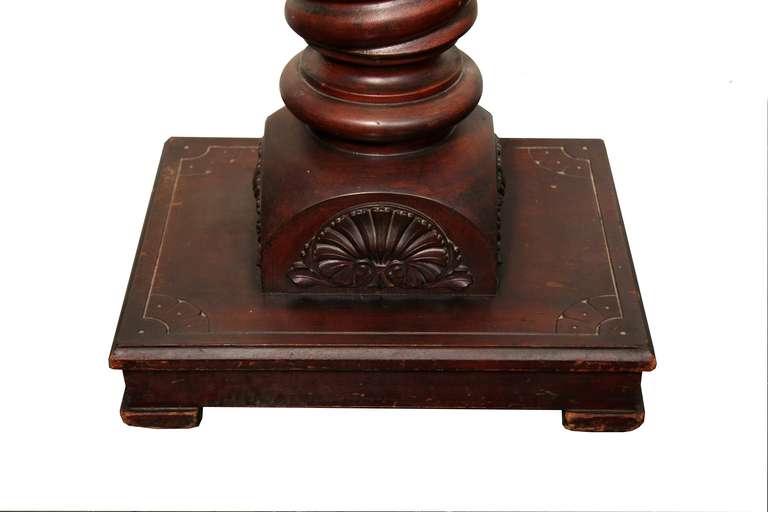 Solid wood pedestal in rosewood. Level platform on large twist base and level legs. Great red/brown hue in grain and weighted nicely. No missing detail or chips, top has minor wear.