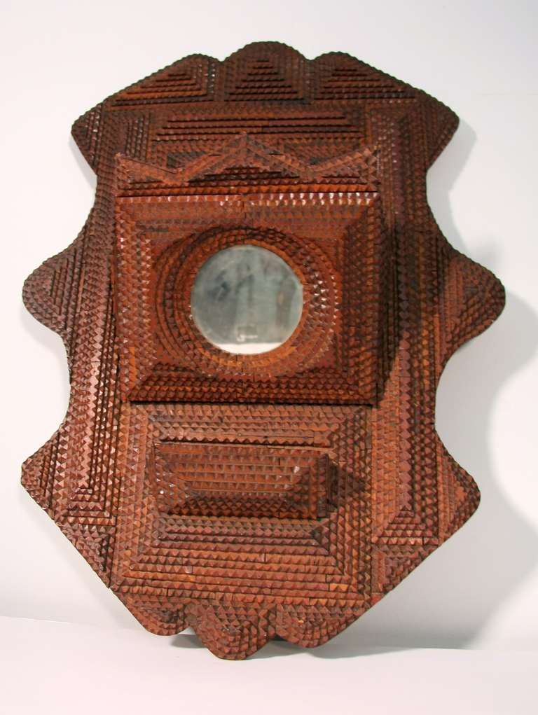 Highly layered and carved wall hanger. A small and large pocket with round mirror.