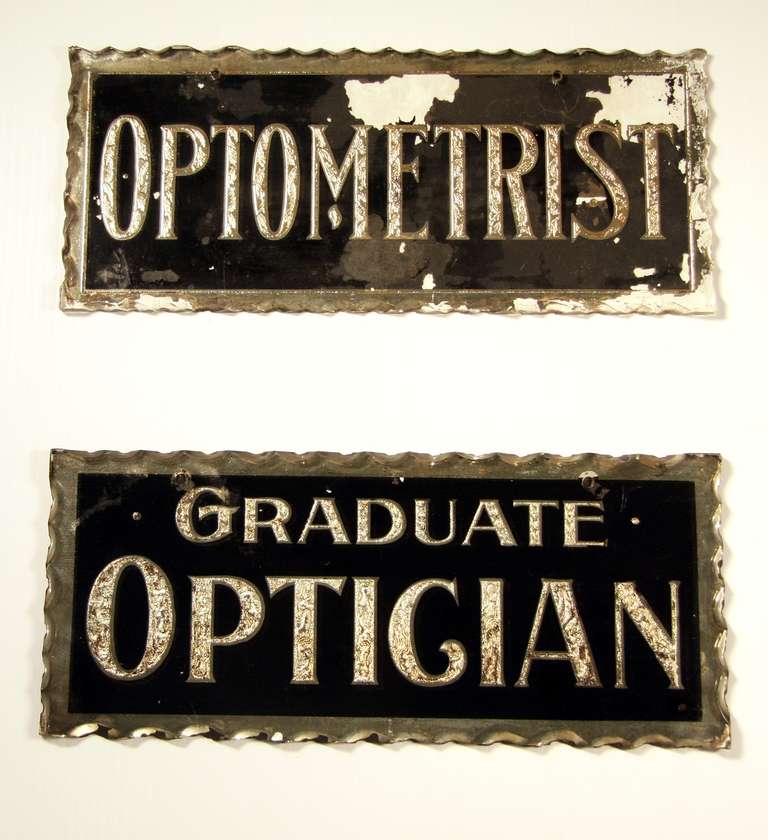 2 Beautiful glass signs for an optometrist office. Decoratively beveled edges and letters are engraved and gold leafed. Black background.