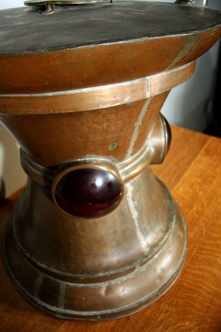 Large mortar and pestle. Fabricated in brass with zinc welding. Red glass details on three sides. Originally used for pharmacy signage.
