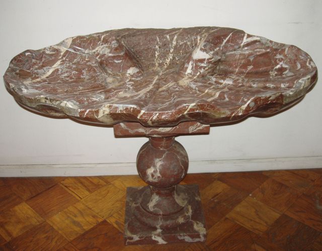 This 18th century wall mounted Italian Marble Fountain in shallow scalloped form, was specifically carved for garden use. Its water supply may have been drawn from a natural spring. The quality of the carving is extremely fine and the choice of