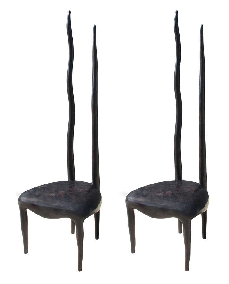 A limited edition pair of sculptural tortoise shell veneer dining chairs by R&Y Augousti. France, 1980's.  A sculptural and oversized set of high back dining chairs veneered in tesselated Tortoise shell. Designed by the husband and wife team of Ria