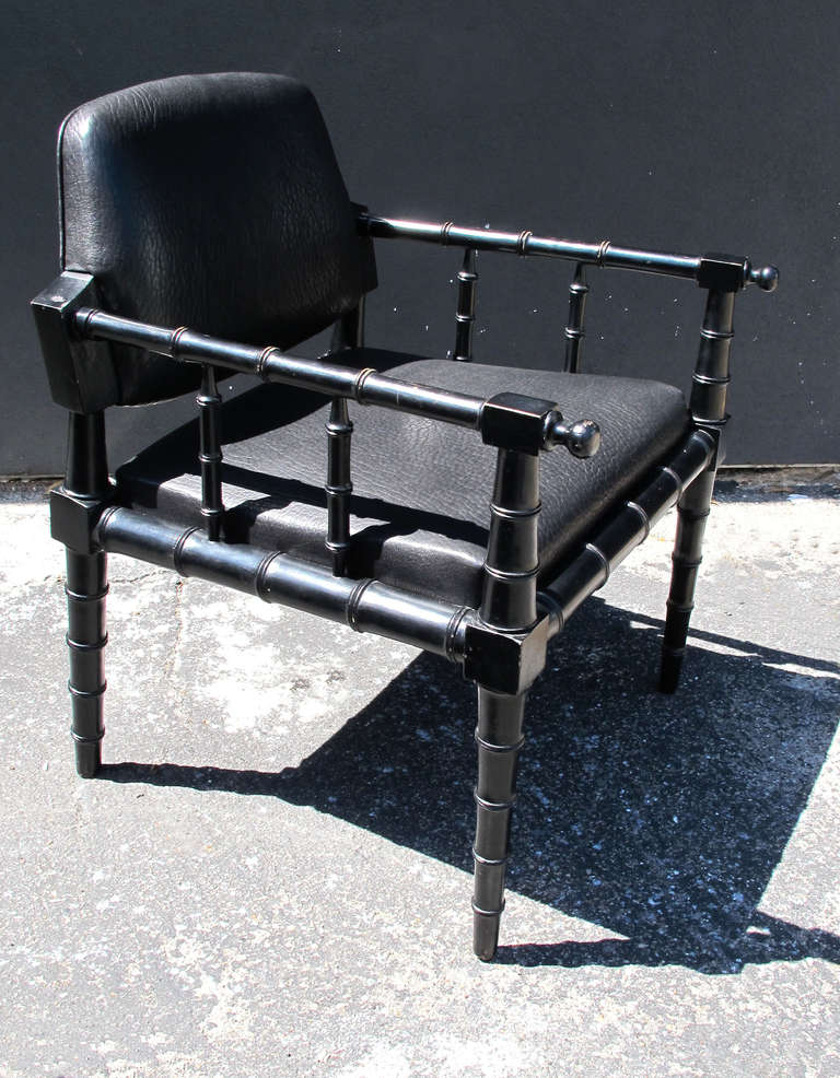 A Pair of Lacquered Faux Bamboo Armchairs. This unique set of armchairs has been recently been re-upholstered in Black Bubbly New Zealand lamb. The chairs show some wear in the black finish but are in overall good condition.