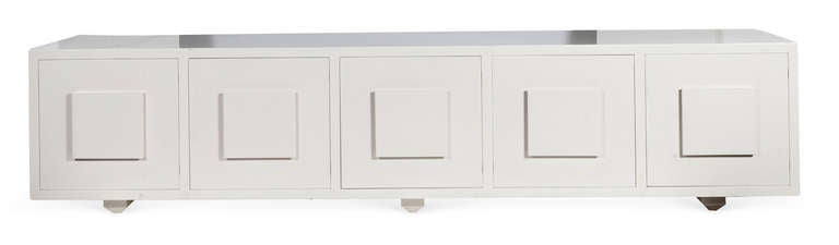 A Five-Door Lacquered Console. USA, 1950s. A Gorgeous and simple low lacquered console in white. Raised beveled squares for pulls.