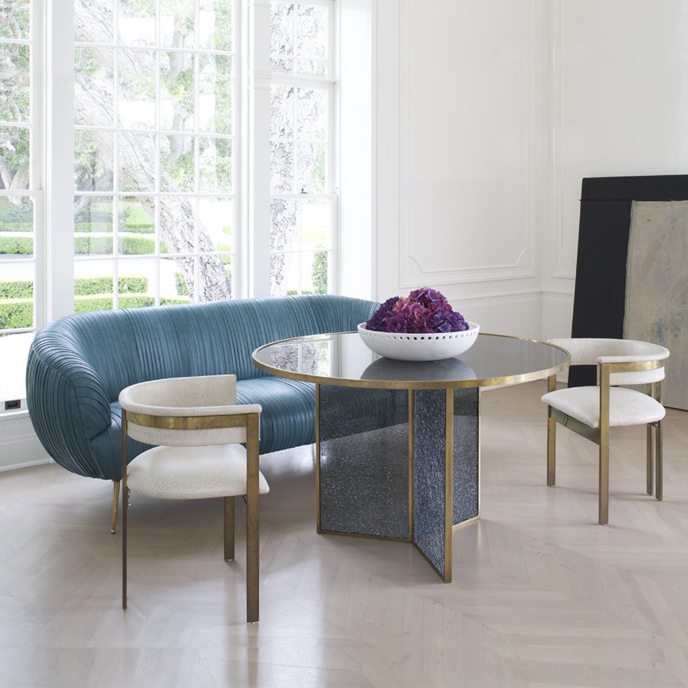 The delicate lines of this sofa are created by a signature ruched leather detail. The kiln-dried hardwood frame is double-doweled and glued, with 8-way hand-tied springs. Full-finish, vegetable dyed lambskin is hand-stitched on to the frame. This
