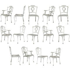 A Set of 14 Ornately Decorated Cast Iron Cafe Chairs
