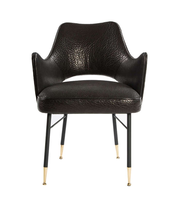 This elevated armchair mixes mid-century European flair with a modern silhouette and is as comfortable in a dark-wood clad home library as it is in a formal dining room. The Rigby Chair features softly curved arms and a slightly pitched back for