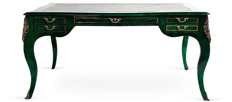 A Louis XV Gilt Bronze Emerald Lacquered Desk. A gorgeous Emerald Green lacquered desk with gilt embossed inset leather blotter. Mounted with delicate gilt bronze hardware and sitting on flared legs. This desk is in excellent original un-restored