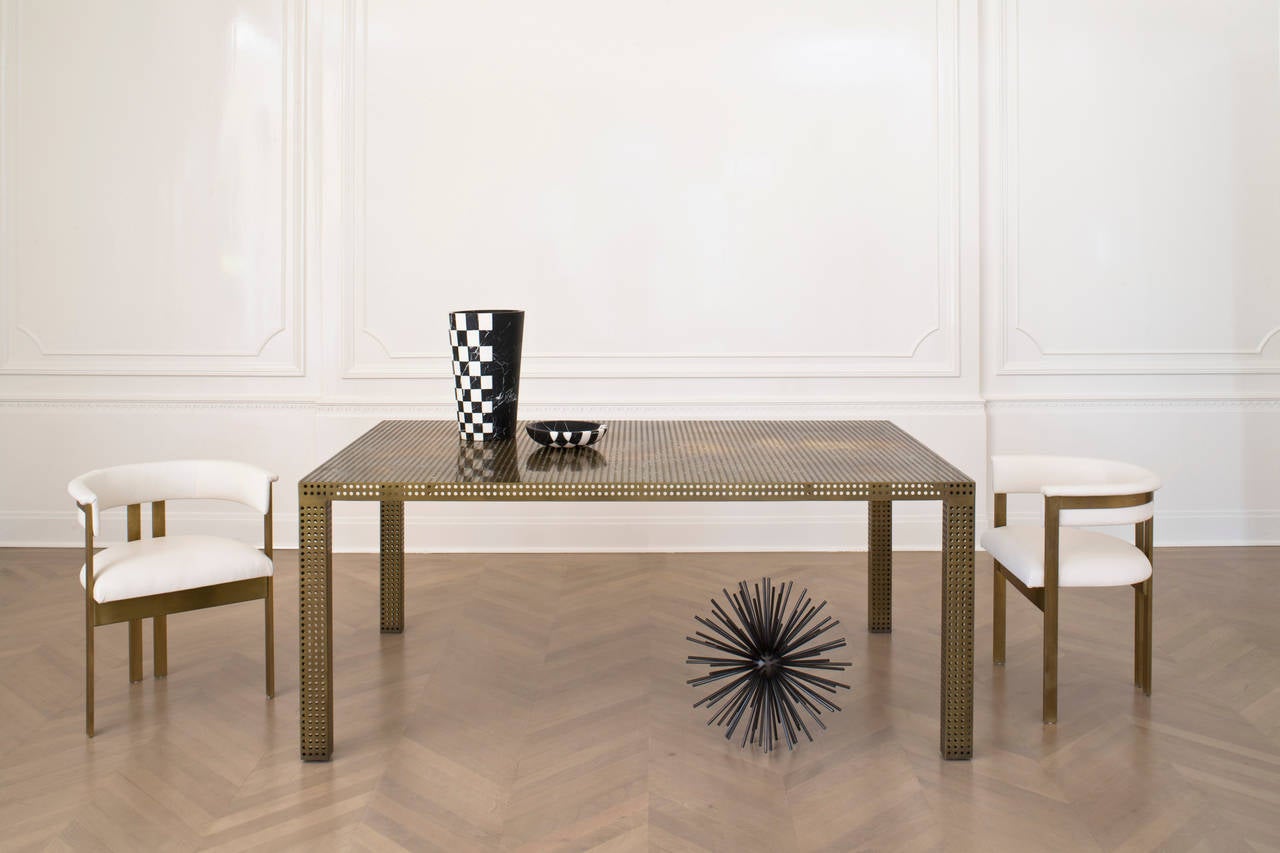 Made from a signature graphic pattern, this simple, modern form is an updated take on a classic. Executed in unlacquered polished bronze, the perforated top, apron, and legs give the table a modern elegance. 

The Precision Table can be made to