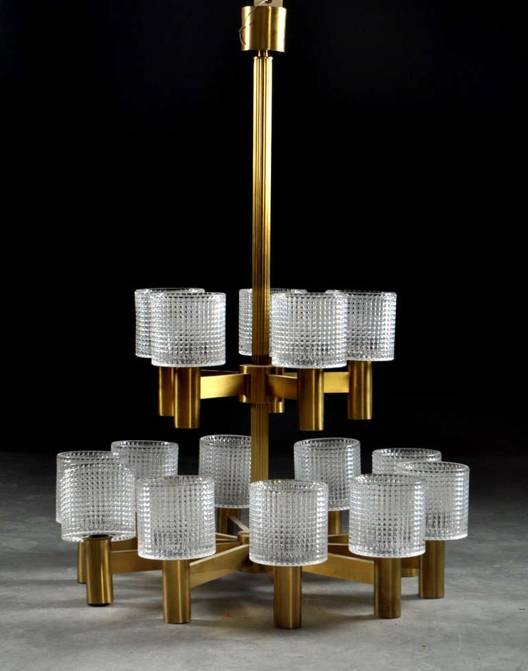 Hans Agne Jacobsson Very Grand 15-Light Brass & Crystal Glass by ORREFORS Chandeliers 
2 Levels, lower level 10 arms/10 lights, upper level 5 arms/5 lights
max.60Watt each light

The height can of course be adjusted by either using the long