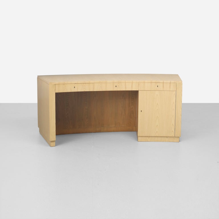 Rare Large 'BIRKA' two-sided Desk by Axel-Einar Hjorth for NK, Nordiska Kompaniet.
The desk features three drawers and one door concealing four shallow pull-out trays with two built-in bookshelves to the opposite side. Signed with applied disc