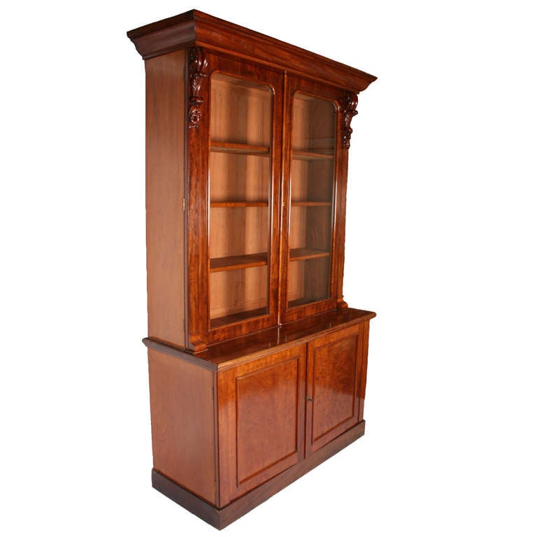 A fine 19th century Victorian mahogany bookcase.

The bookcase has two glazed doors over two cupboard doors, the top having three adjustable shelves with rounded mahogany front edges.

The carved decorations to the top of the doors have