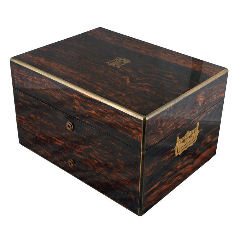An exceptional quality 19th century Victorian coromandel wood veneered jewel or dressing box.

The box has brass edging and the interior is fitted out with fourteen sterling silver topped jars and bottles.

The box was made by 'Wells & Lambe