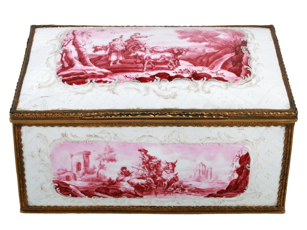 An 18th century Battersea enamel casket of unusually large dimensions.

The casket has wonderful landscape scenes painted to the four bow sides and the dome lid, each panel is held within a gilt metal frame. The lid hinges open to an interior that