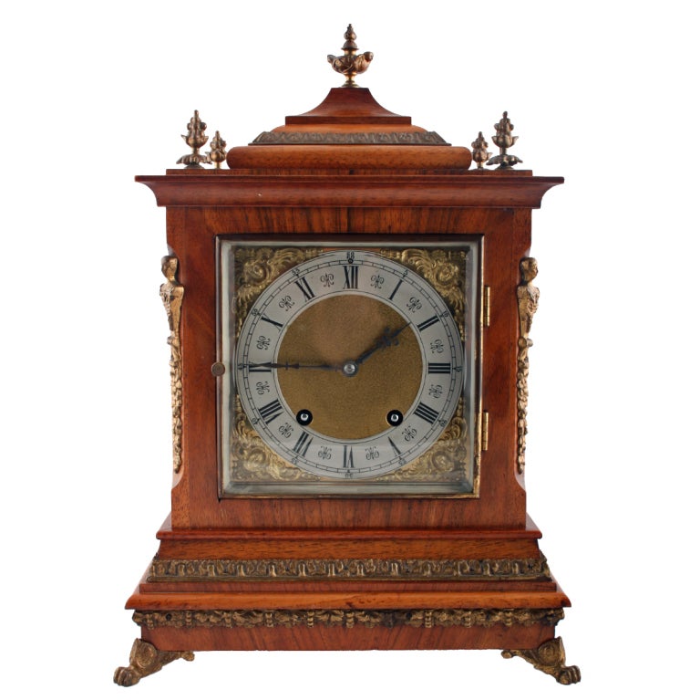A late 19th century Victorian walnut cased Lenzkirch bracket style clock.

The clock has gilt bronze mounts, feet, finials and side grilles while the eight day movement works strike the quarter, half and hour on a pair of curled gongs.

The