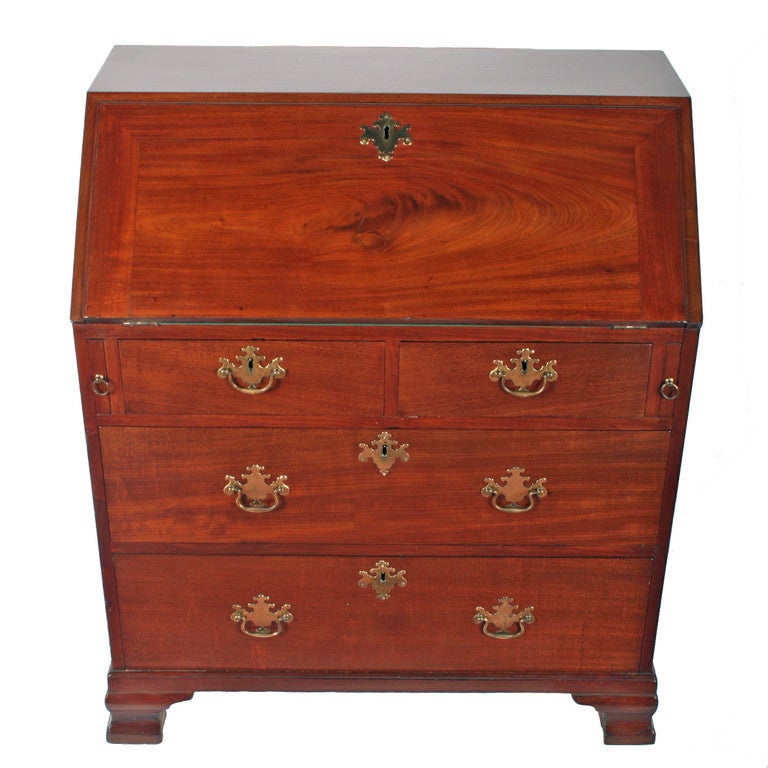 An 18th century small George III mahogany bureau. 

The bureau stands on ogee shaped feet, has two small drawers over two graduated drawers, all oak lined and with their original gilt brass handles. 

The interior of the bureau has seven pigeon