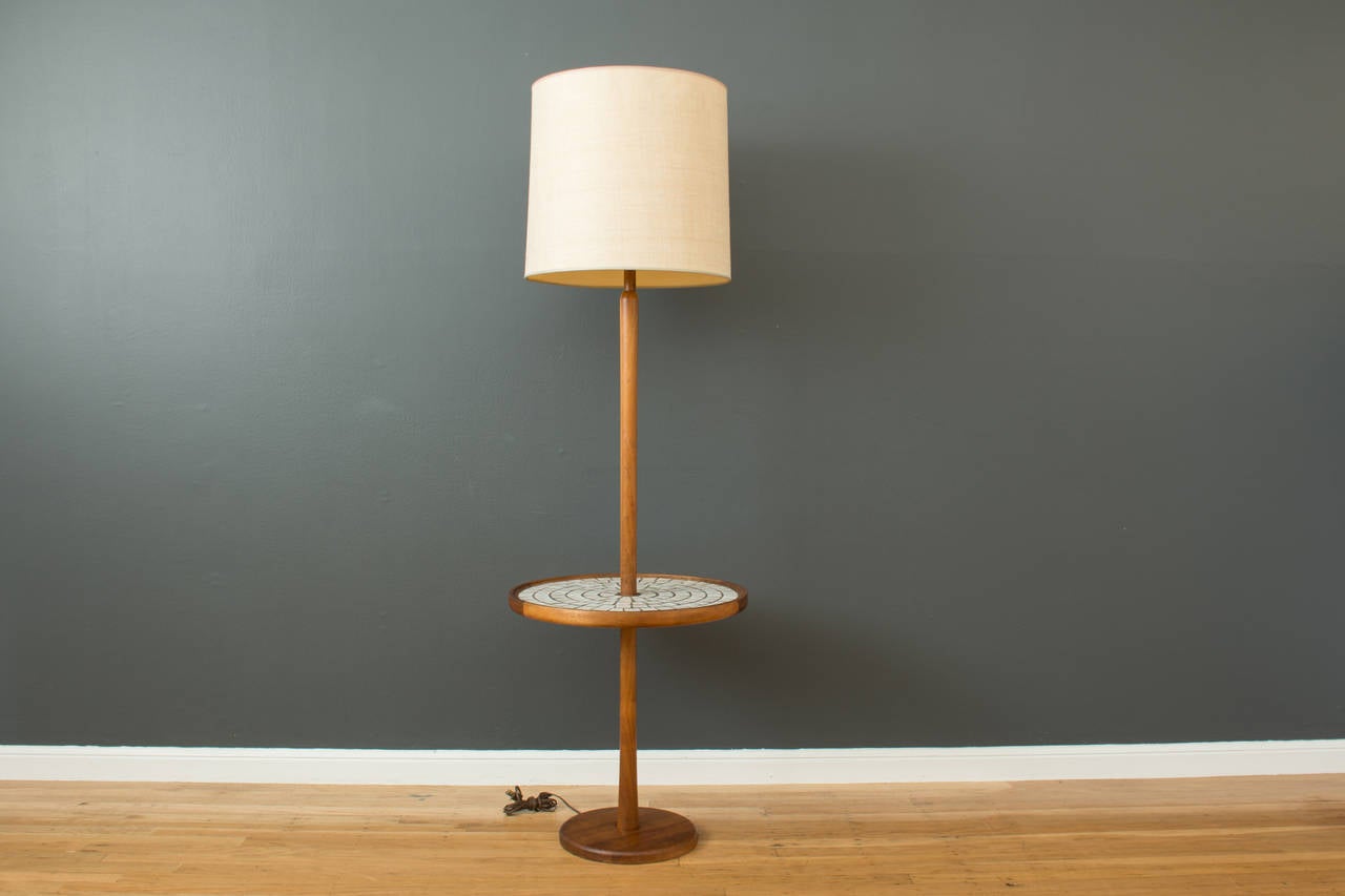 This is a Mid-Century Modern floor lamp by Gordon and Jane Martz for Marshall Studios.  It is solid walnut with a ceramic tile table top. Shade not included.