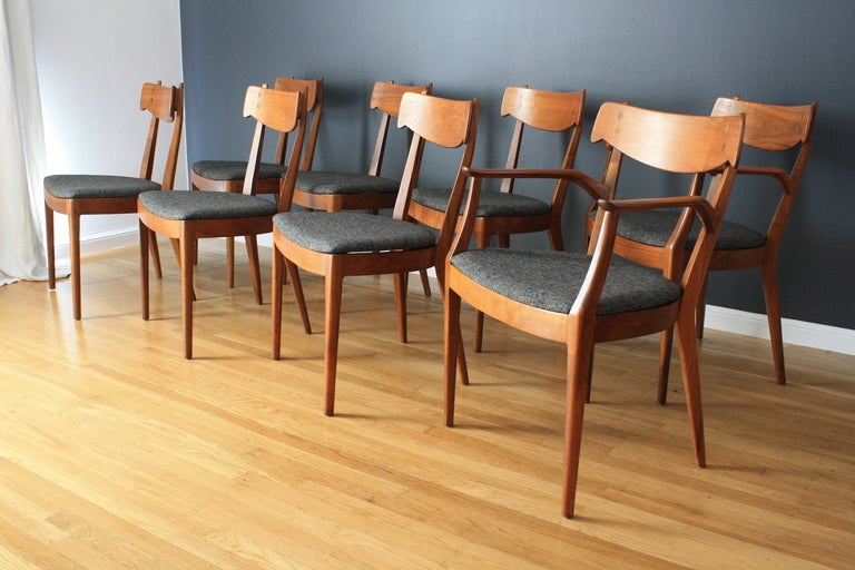 This is a vintage dining table and eight chairs by Kipp Stewart and Stuart MacDougall for Drexel's Declaration line.  The chairs are walnut with rosewood in-lays and have been professionally reupholstered.  They measure 32