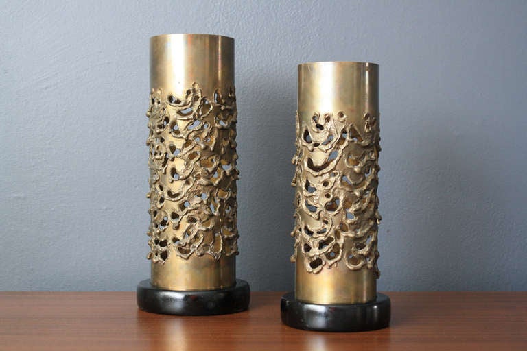 This is a pair of vintage brutalist candle holders by modernist architect, Robert Stanton (1900-1983). They are brass with black wood bases. The bigger one measures 12.5