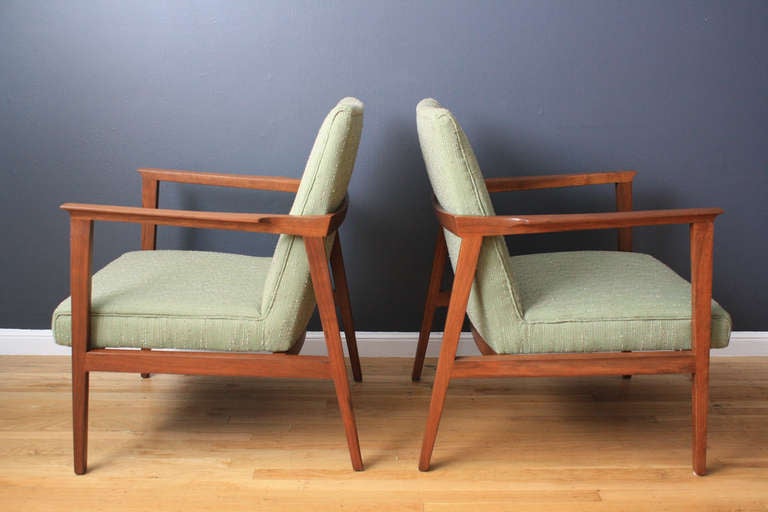 This is a pair of vintage Mid-Century lounge chairs designed by Edward Wormley for Dunbar in the 1950's. They have walnut frames and the original upholstery.