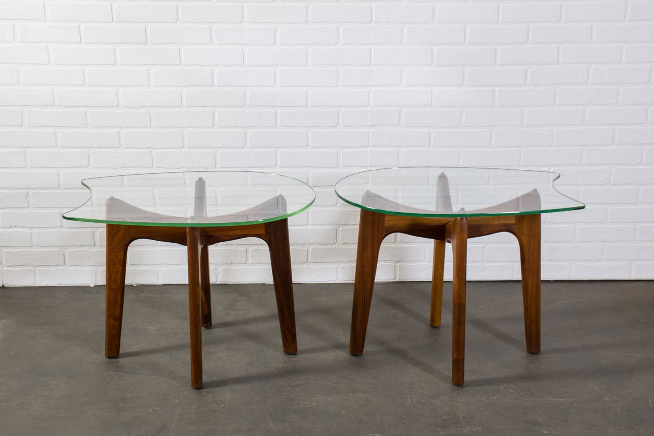 This is a pair of vintage Mid-Century side tables by Adrian Pearsall.  They have sculptural walnut bases and the original glass tops.