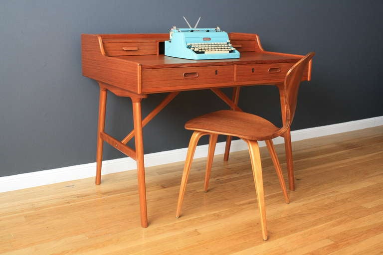 This is a vintage Mid-Century teak writing desk designed by Arne Wahl Iversen in the 1960's for Vinde Mobelfabrik. It features fours drawers, and the key is included for the bottom two. The height to the desk top is 29