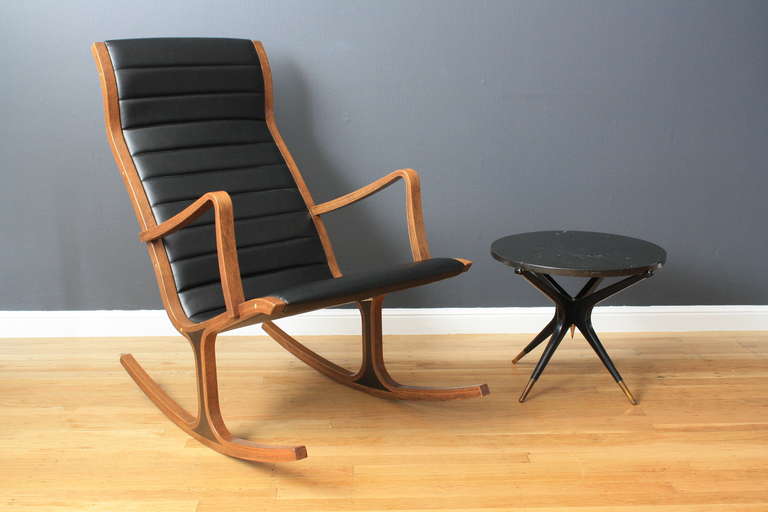 This is a vintage Mid-Century Heron rocking chair designed by Mitsumasa Sugasawa for Tendo Mokko. Professionally reupholstered in black faux leather.