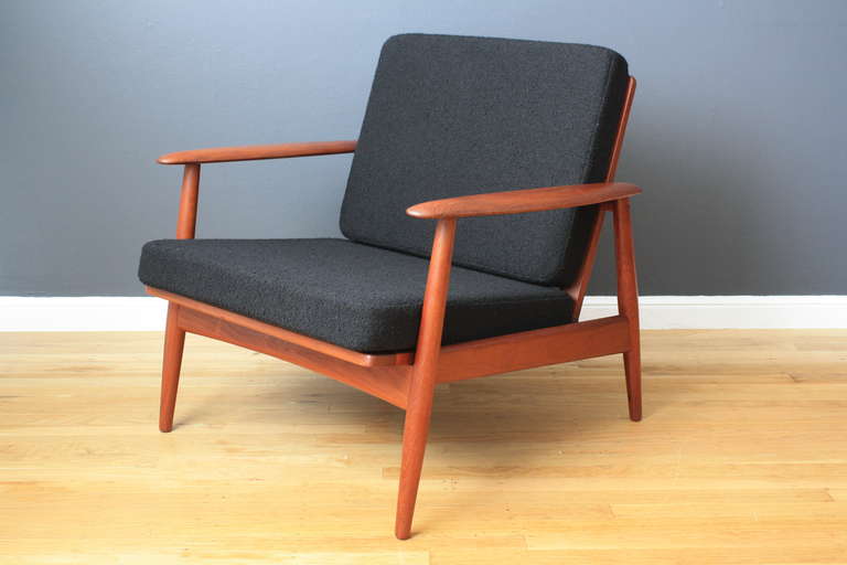This is a vintage Mid-Century lounge chair.  It has a teak frame and new cushions upholstered in black wool.