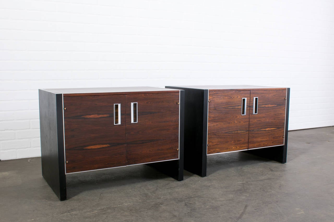 This is a pair of Mid-Century Modern nightstands designed by Robert Baron for Glen of California, circa 1960s. They are rosewood with ebonized oak sides and chrome pulls and trim. The interior is maple.