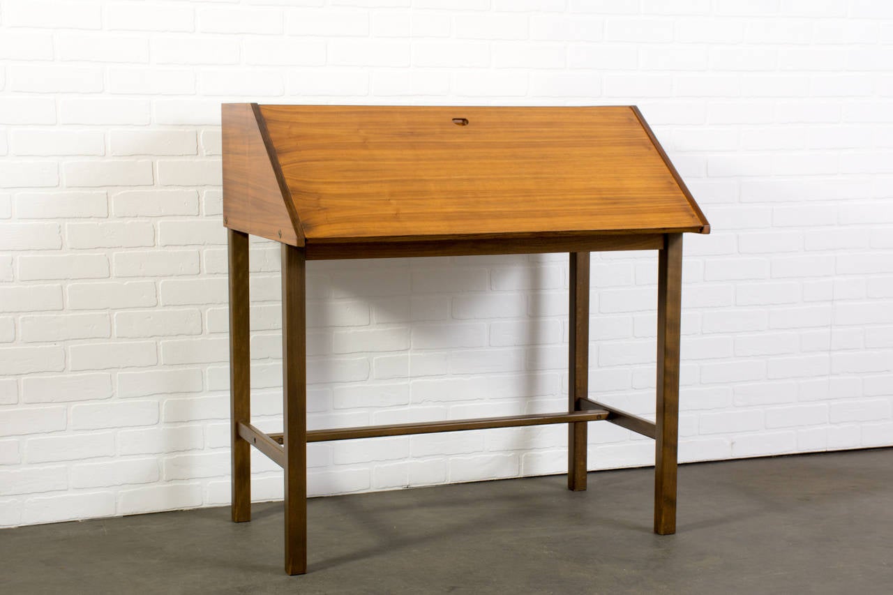This is a vintage Mid-Century secretary desk.  The top opens to reveal two small drawers and shelves.

Measurements:

35.5