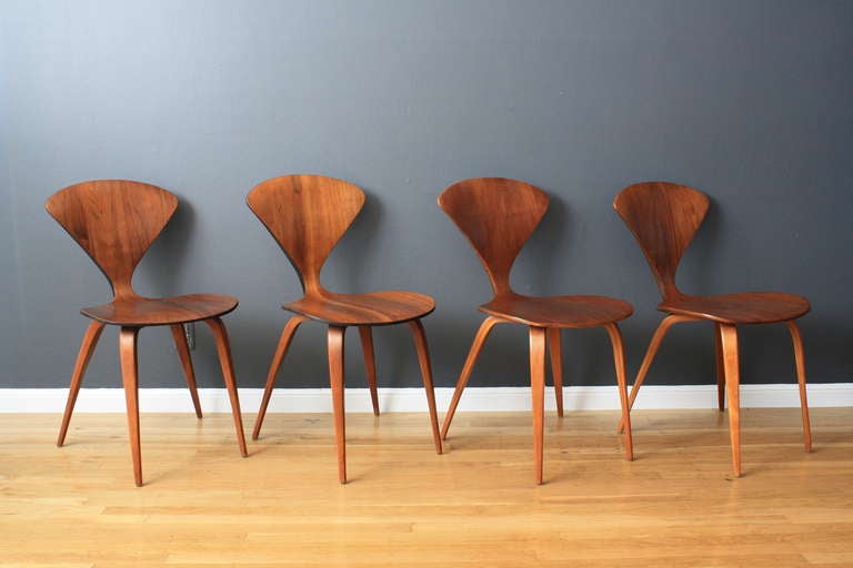 This is a set of eight Mid-Century Modern molded plywood dining chairs designed by Norman Cherner in 1958 for Plycraft. Great condition with minor vintage wear.  These chairs would work well as a set of 10 with the two Cherner 