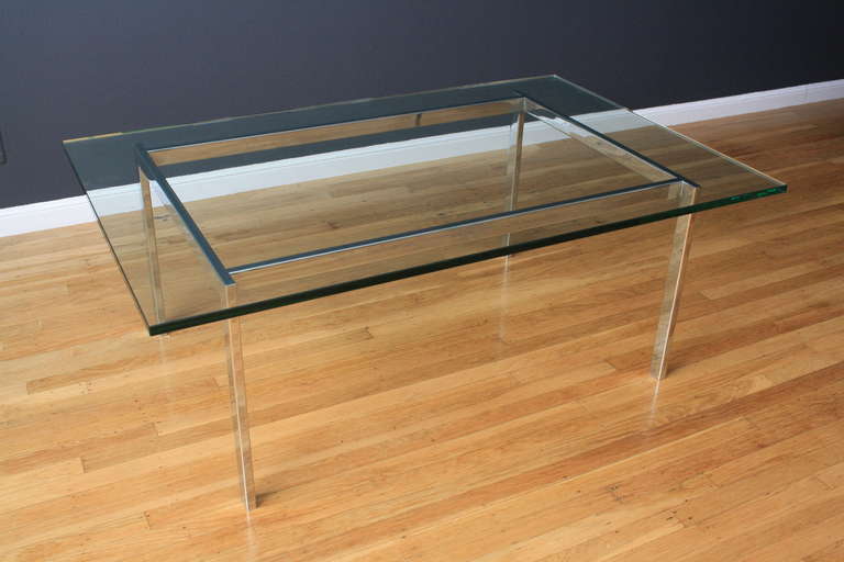 This is a Mid-Century Modern Coffee table with a chrome base and glass top.
