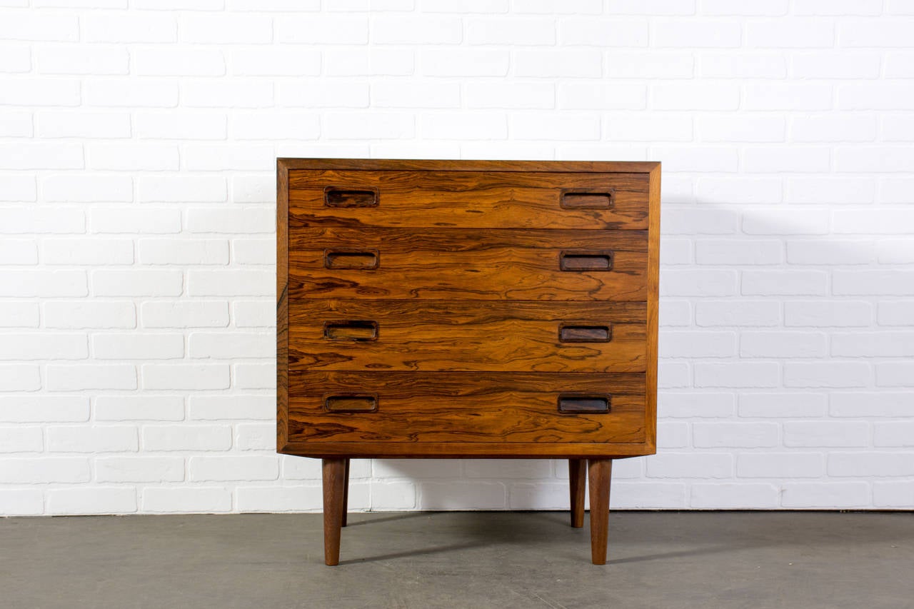 This is a Danish Modern small rosewood dresser by Poul Hundevad.  It has four drawers.