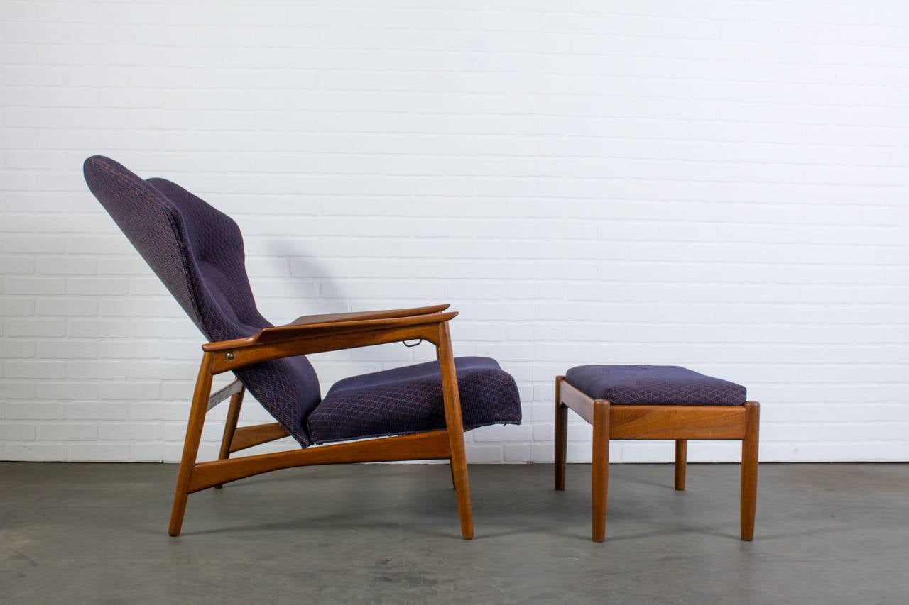 This is a Danish modern high back lounge chair and ottoman designed by Ib Kofod-Larsen for Carlo Gahrn in 1954. It has a solid teak frame and original upholstery. Can be adjusted in three positions. Beautiful wingback design.