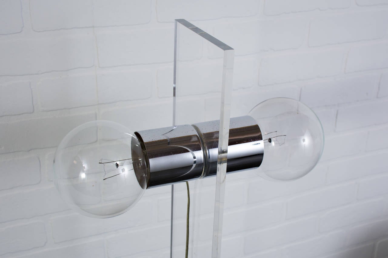 This is a vintage Mid-Century lucite (acrylic) floor lamp with chrome details. It has a foot switch on the cord.