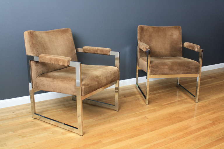 This is a pair of Mid-Century Modern lounge chairs with chrome plated frames and the original upholstery.